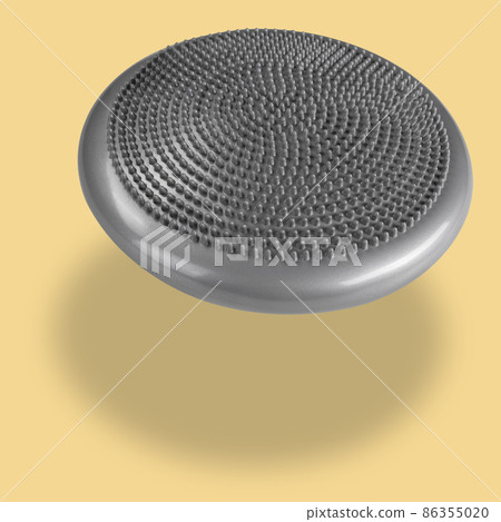 balancing massage pillow, levitates, on a yellow background, concept 86355020