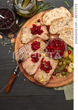 Sliced Traditional French terrine covered with bacon on dark wooden background Sliced Traditional French terrine covered with bacon on dark wooden background 86355555