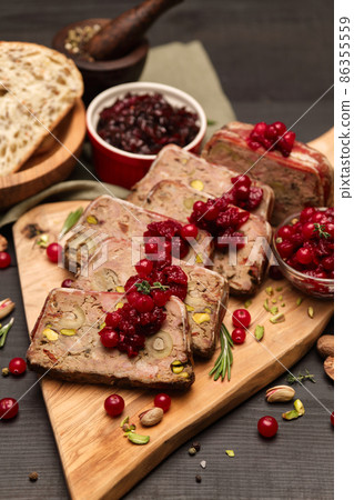 Sliced Traditional French terrine covered with bacon on dark wooden background Sliced Traditional French terrine covered with bacon on dark wooden background 86355559