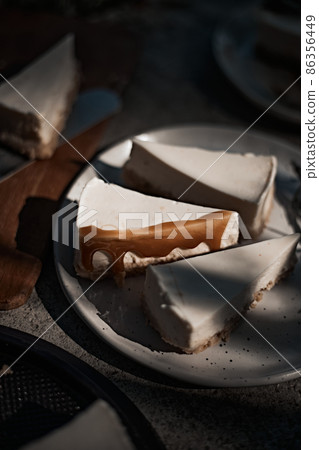 Slice of cheesecake with caramel sauce 86356449