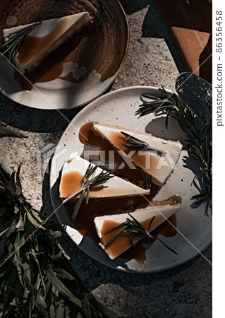 Slice of cheesecake with caramel sauce 86356458