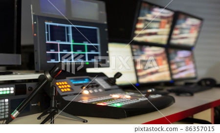 Television director's office with remote control and microphone, monitors, sensors, copy space 86357015