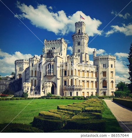 Beautiful old white castle with castle garden in summer sunny day with blue sky in the background. Concept for architecture, travel and tourism. Hluboka nad Vltavou - Czech Republic - Europe. 86357044