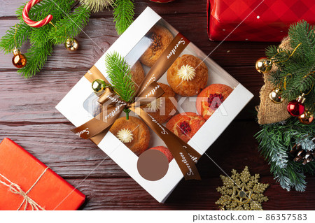 Christmas dessert shu cake in box on wooden background Christmas dessert shu cake in box on wooden background 86357583