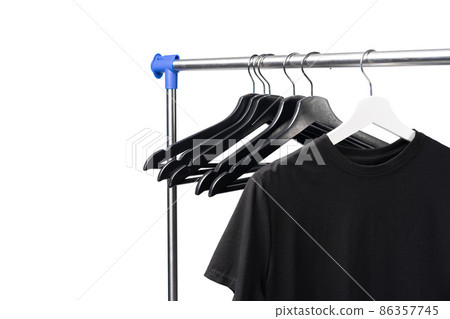 Black T-shirt on hangers on metal rack isolated on white background 86357745