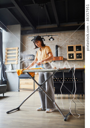 Young Woman doing Chores at Home Young Woman doing Chores at Home 86357951