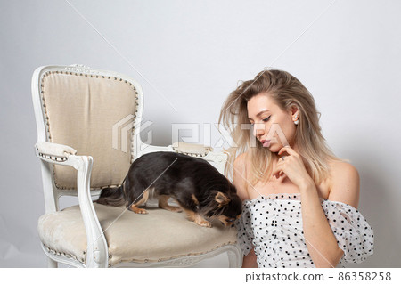 Woman with blonde hair on grey Woman with blonde hair on grey 86358258