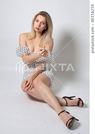 Woman with blonde hair on grey Woman with blonde hair on grey 86358259