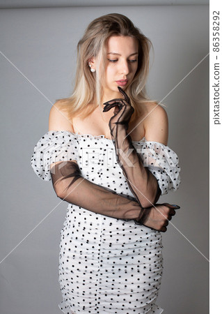 Woman with blonde hair on dark grey Woman with blonde hair on dark grey 86358292