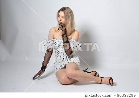 Woman with blonde hair on dark grey 86358299