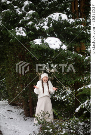 White european young woman in winter forest 86358537