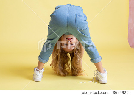 White european baby girl isolated on yellow White european baby girl isolated on yellow 86359201