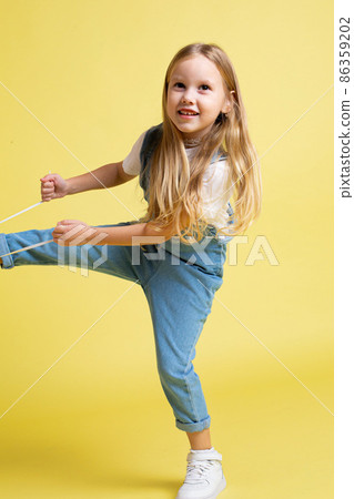 White european baby girl isolated on yellow White european baby girl isolated on yellow 86359202