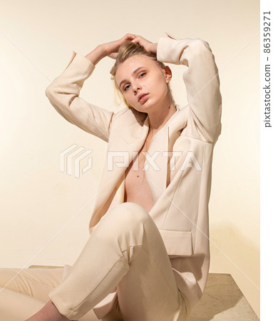 White young european woman isolated on beige 86359271