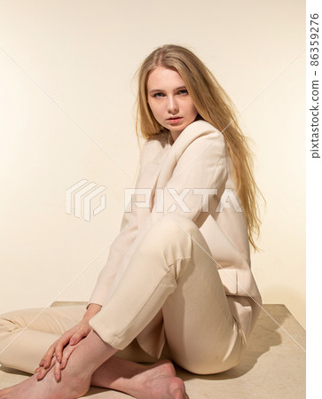 White young european woman isolated on beige White young european woman isolated on beige 86359276