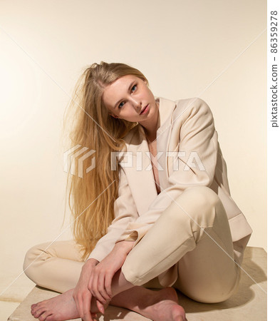White young european woman isolated on beige White young european woman isolated on beige 86359278