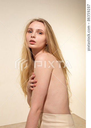 White young european woman isolated on beige 86359287
