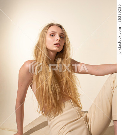 White young european woman isolated on beige White young european woman isolated on beige 86359289