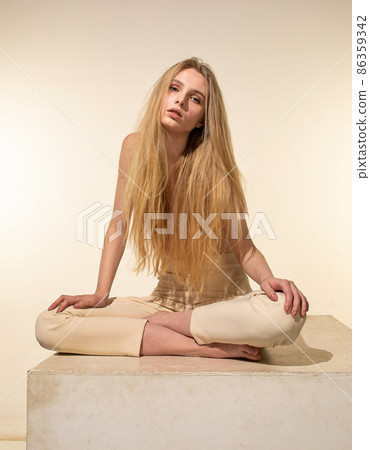 White young european woman isolated on beige 86359342