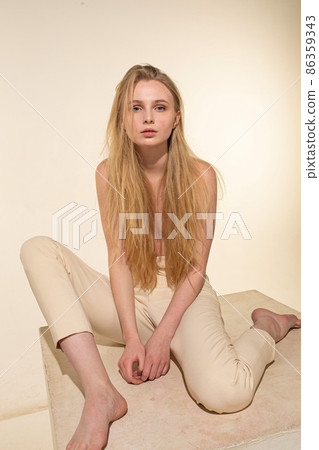 White young european woman isolated on beige 86359343