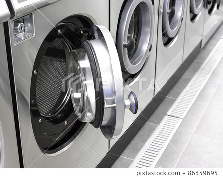 Industrial washing machines in a public laundromat 86359695