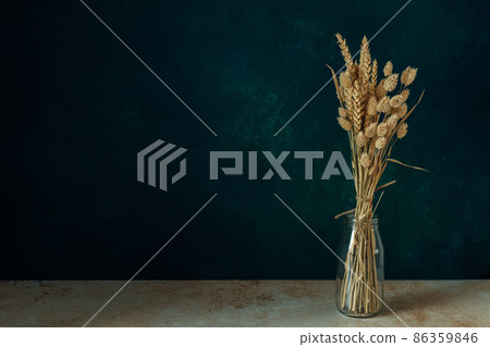 Minimalistic bouquet of beautiful dried flowers on dark background. Minimalistic bouquet of beautiful dried flowers on dark background. 86359846