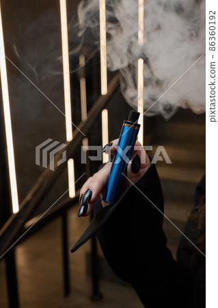 disposable electronic cigarettes in hand. The concept of modern smoking, vaping and nicotine. disposable electronic cigarettes in hand. The concept of modern smoking, vaping and nicotine. 86360192