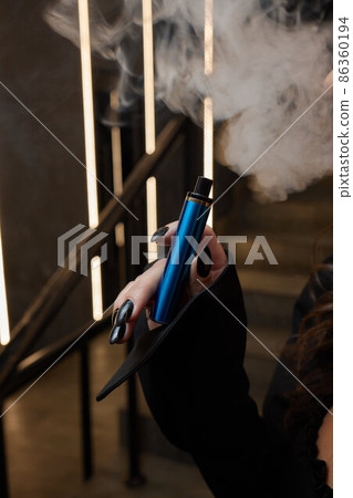 disposable electronic cigarettes in hand. The concept of modern smoking, vaping and nicotine. disposable electronic cigarettes in hand. The concept of modern smoking, vaping and nicotine. 86360194
