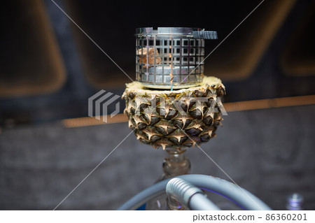 Stylish hookah with the aroma pineapple for relax.Pineapple shisha.Hookah lounge. Stylish hookah with the aroma pineapple for relax.Pineapple shisha.Hookah lounge. 86360201