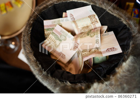 Elderly man counts russian rubles in hands. Pension payments, retirement savings or benefits concept, male pensioner with paper currency of Russia. 86360271