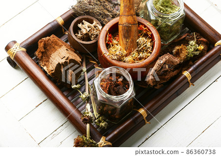 Tray with healing herbs. 86360738
