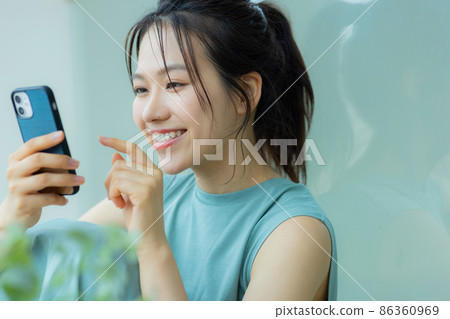 A woman watching a smartphone 86360969