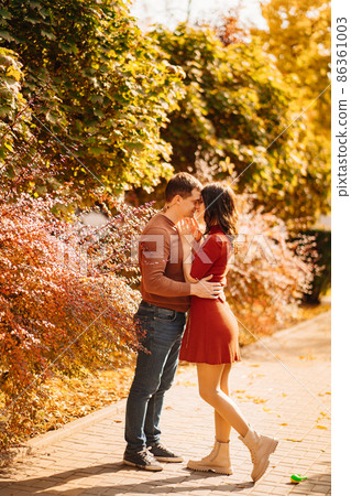 a beautiful, happy couple on an autumn walk. a beautiful, happy couple on an autumn walk. 86361003