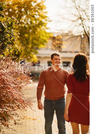 a beautiful, happy couple on an autumn walk. a beautiful, happy couple on an autumn walk. 86361005