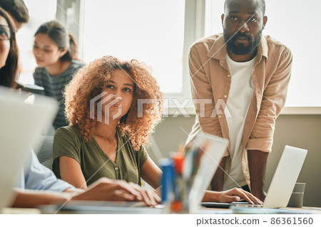 Focused smart woman and her male colleague listening attentively 86361560