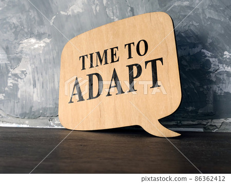 Time to adapt phrase on the wooden desk. 86362412