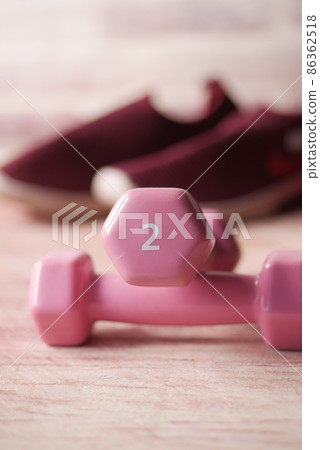 pink color dumbbell, exercise mat and water bottle on white background pink color dumbbell, exercise mat and water bottle on white background 86362518
