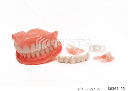 Dentures on a white background. Close-up of dentures. Dentistry is conceptual photography. Prosthetic dentistry. False teeth. Prosthetics. Close-up of plastic denture teeth isolate no fond background Dentures on a white background. Close-up of dentures. Dentistry is conceptual photography. Prosthetic dentistry. False teeth. Prosthetics. Close-up of plastic denture teeth isolate no fond background 86363453