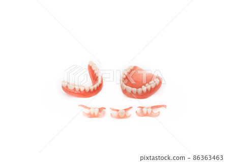 Dentures on a white background. Close-up of dentures. Full removable plastic denture of the jaws. Prosthetic dentistry. False teeth. Close-up of plastic dentures. Teeth on a white background Dentures on a white background. Close-up of dentures. Full removable plastic denture of the jaws. Prosthetic dentistry. False teeth. Close-up of plastic dentures. Teeth on a white background 86363463