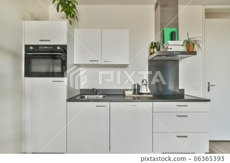 Kitchen in a new luxury home, hardwood floors, dark cabinets Kitchen in a new luxury home, hardwood floors, dark cabinets 86365393