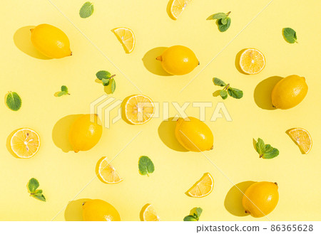 lemons with mint on minimal beige yellow background on bright sun light with hard shadows pattern lemons with mint on minimal beige yellow background on bright sun light with hard shadows pattern 86365628