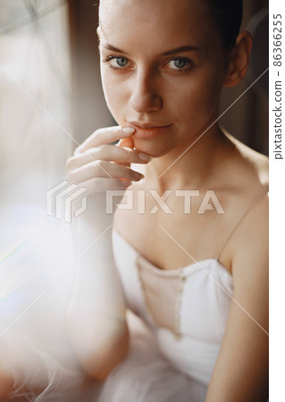 Ballerina posing in front of white background 86366255