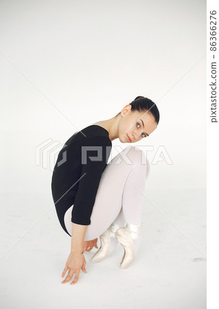 Ballerina posing in front of white background Ballerina posing in front of white background 86366276