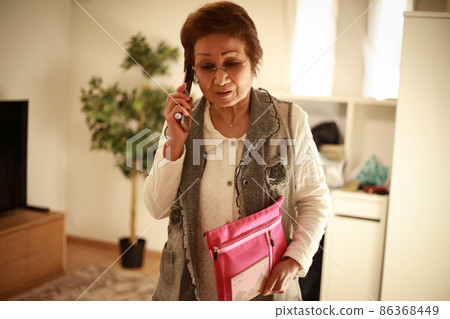 Senior woman talking with a passbook Senior woman talking with a passbook 86368449