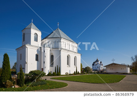 Old ancient catholic Church of St Michael the Archangel. Orthodox church of the Transfiguration of Jesus Christ on background. Smorgon, Grodno region, Belarus. Old ancient catholic Church of St Michael the Archangel. Orthodox church of the Transfiguration of Jesus Christ on background. Smorgon, Grodno region, Belarus. 86368979
