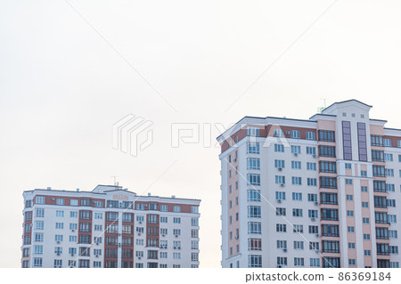 Multi-storey buildings against the sky. The concept of buying a new home or a new residential neighborhood. Buying a new home. Multi-storey buildings against the sky. The concept of buying a new home or a new residential neighborhood. Buying a new home. 86369184