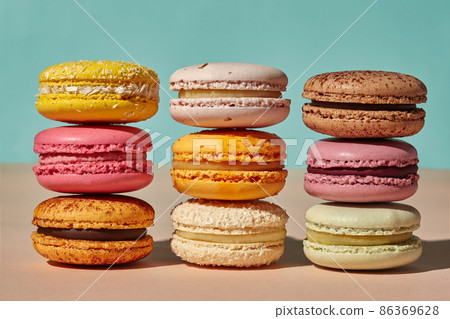 Three stacks of macarons on pink and blue background Three stacks of macarons on pink and blue background 86369628