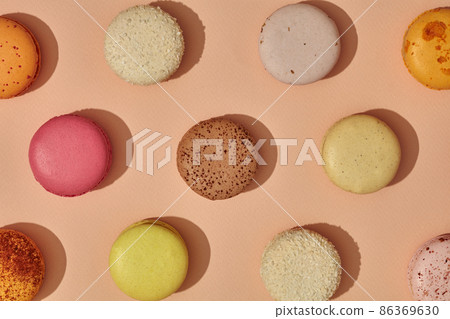 Top view of colorful macarons on light pink background 86369630