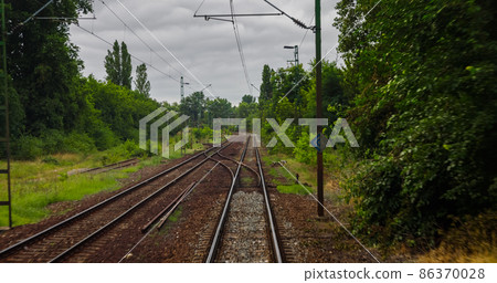 Point of view train travel under cloudy sky 86370028
