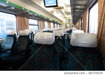 Old train interior with empty seats 86370029